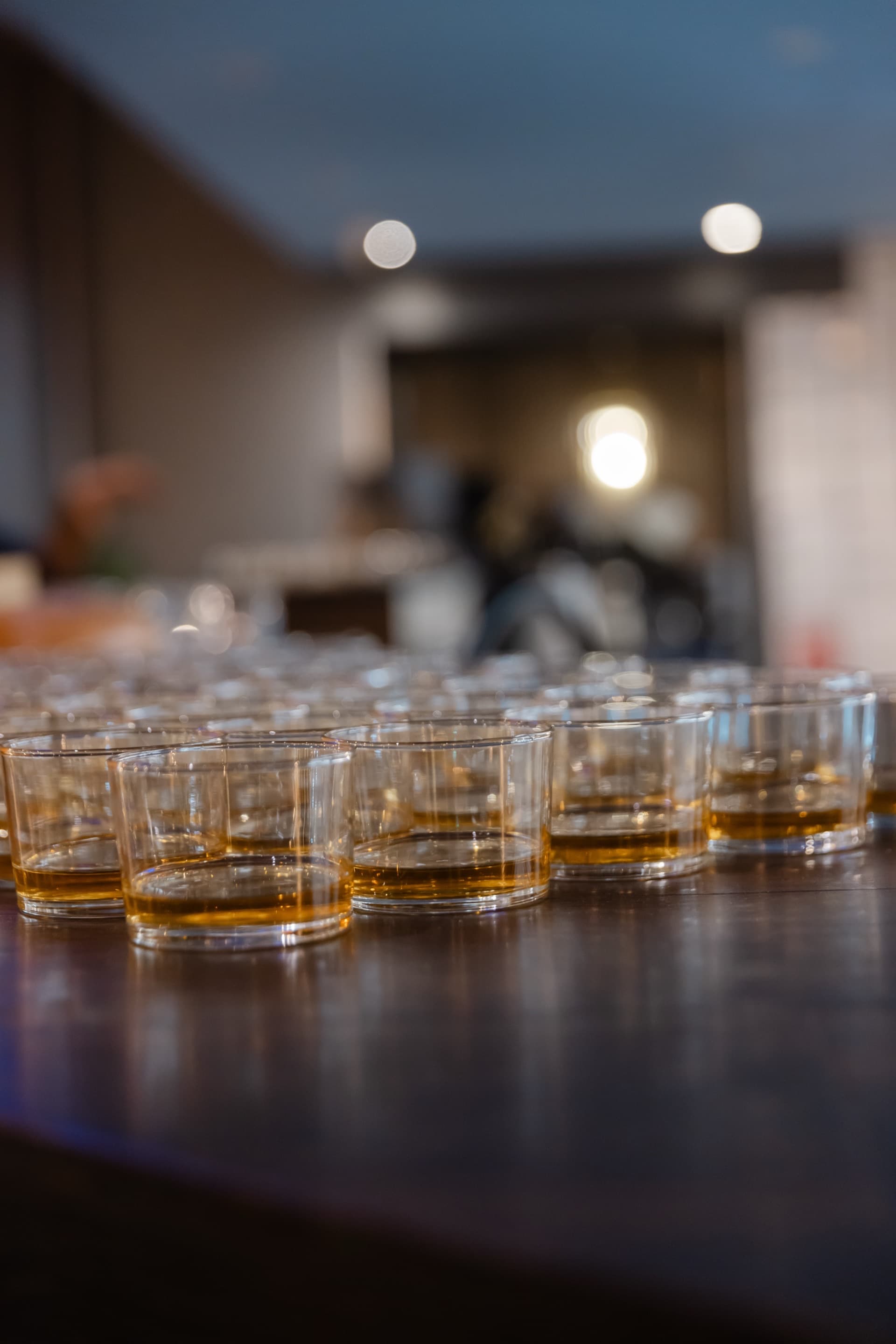 Rows of whisky glasses lined up on the bar at Koyal's whisky tasting evening