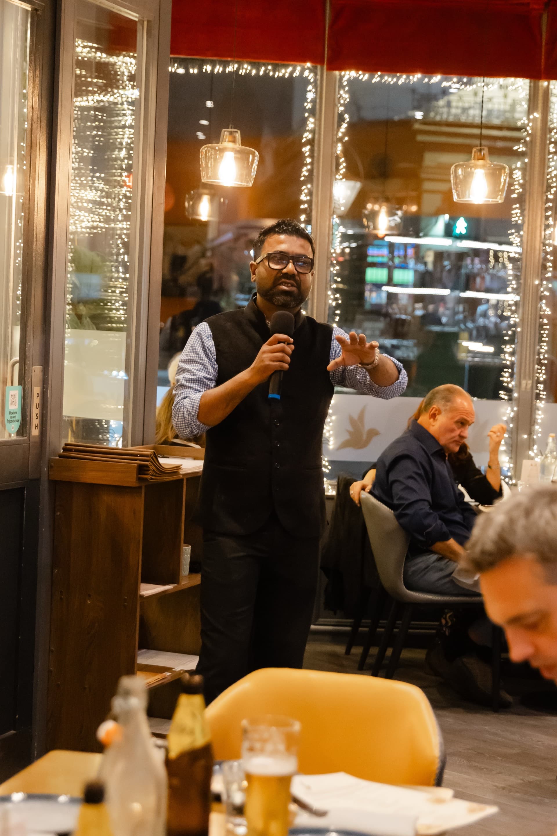 Host presenting the whisky selection to guests at Koyal restaurant